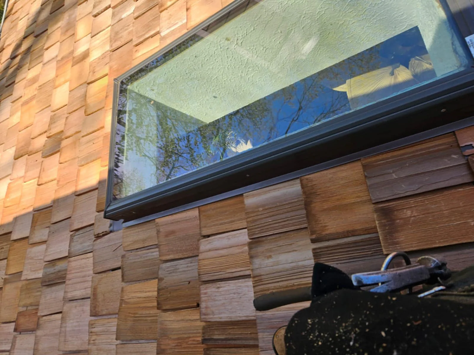 Cedar exterior detail around a modern roof window