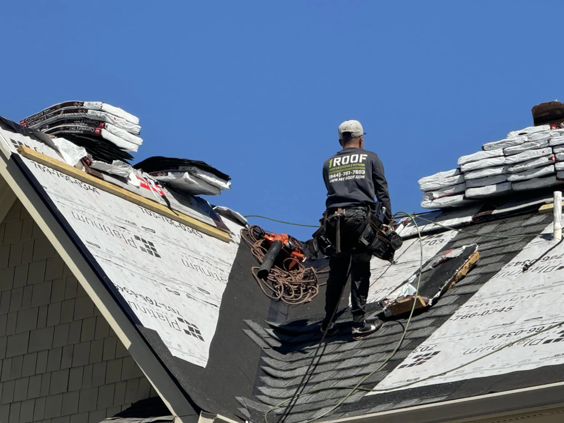 Roofing professional installing architectural shingles