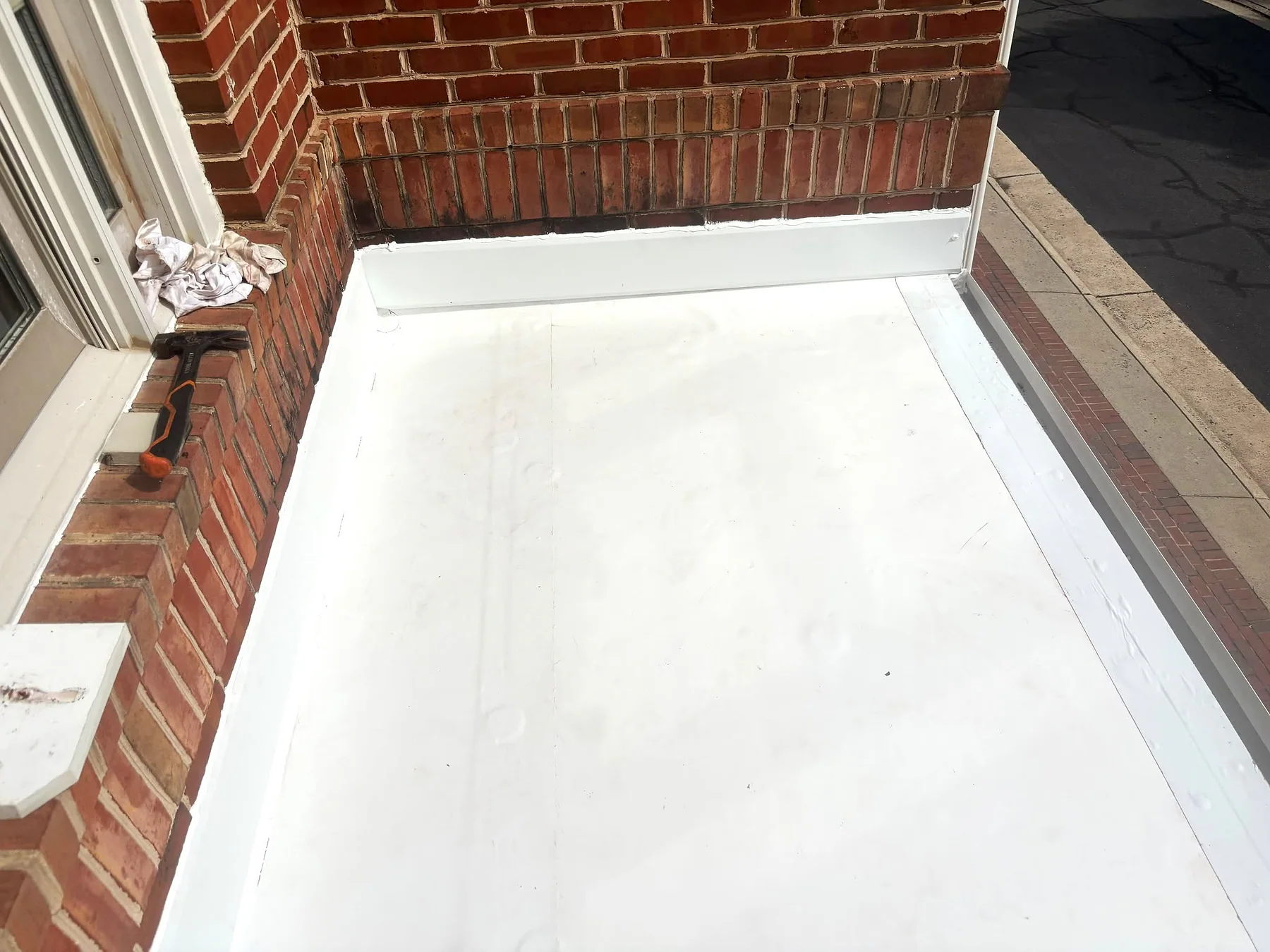 Finished low-slope roof with clean wall and edge transitions
